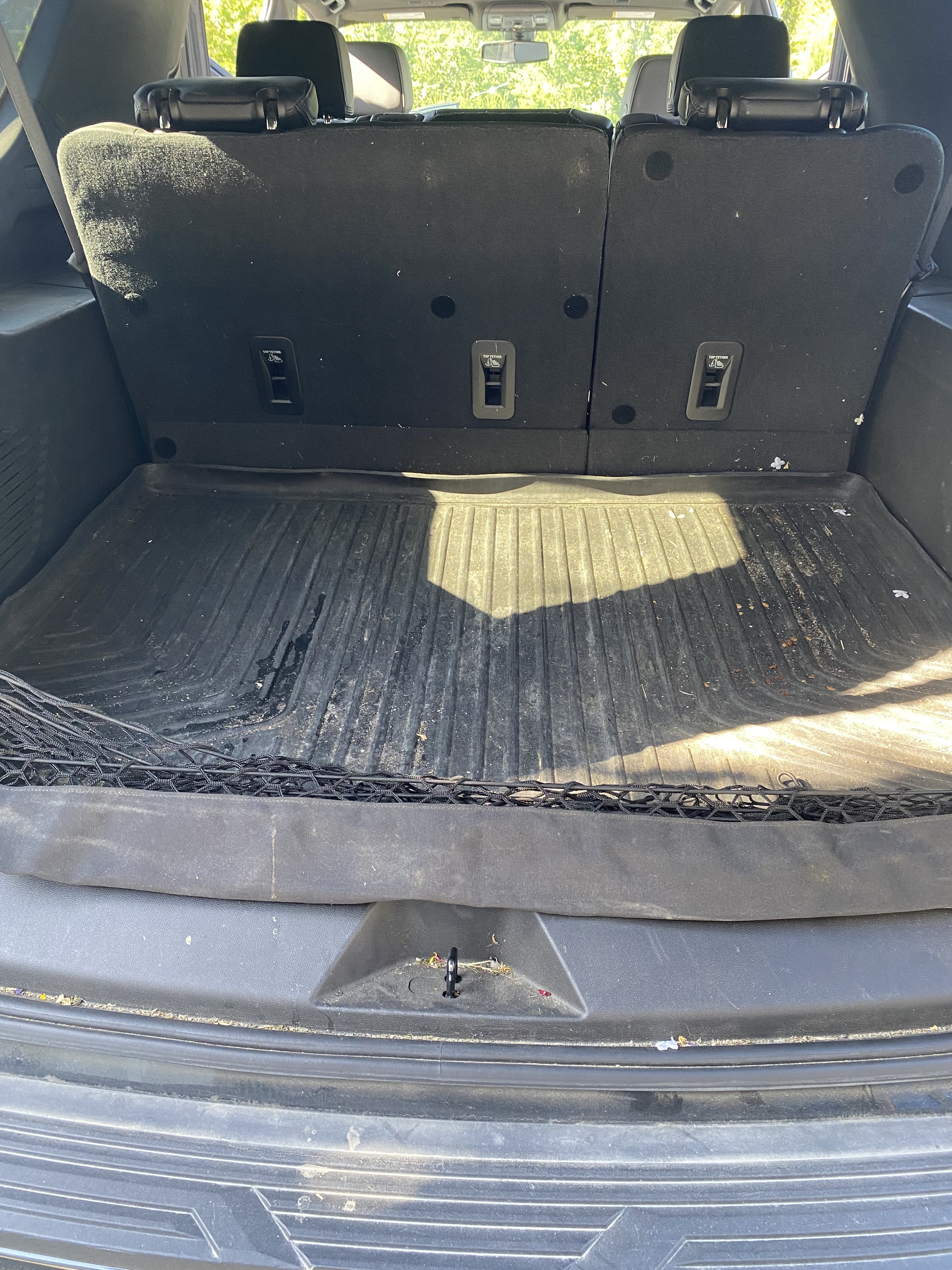 Dirty cargo area of a family SUV before detailing