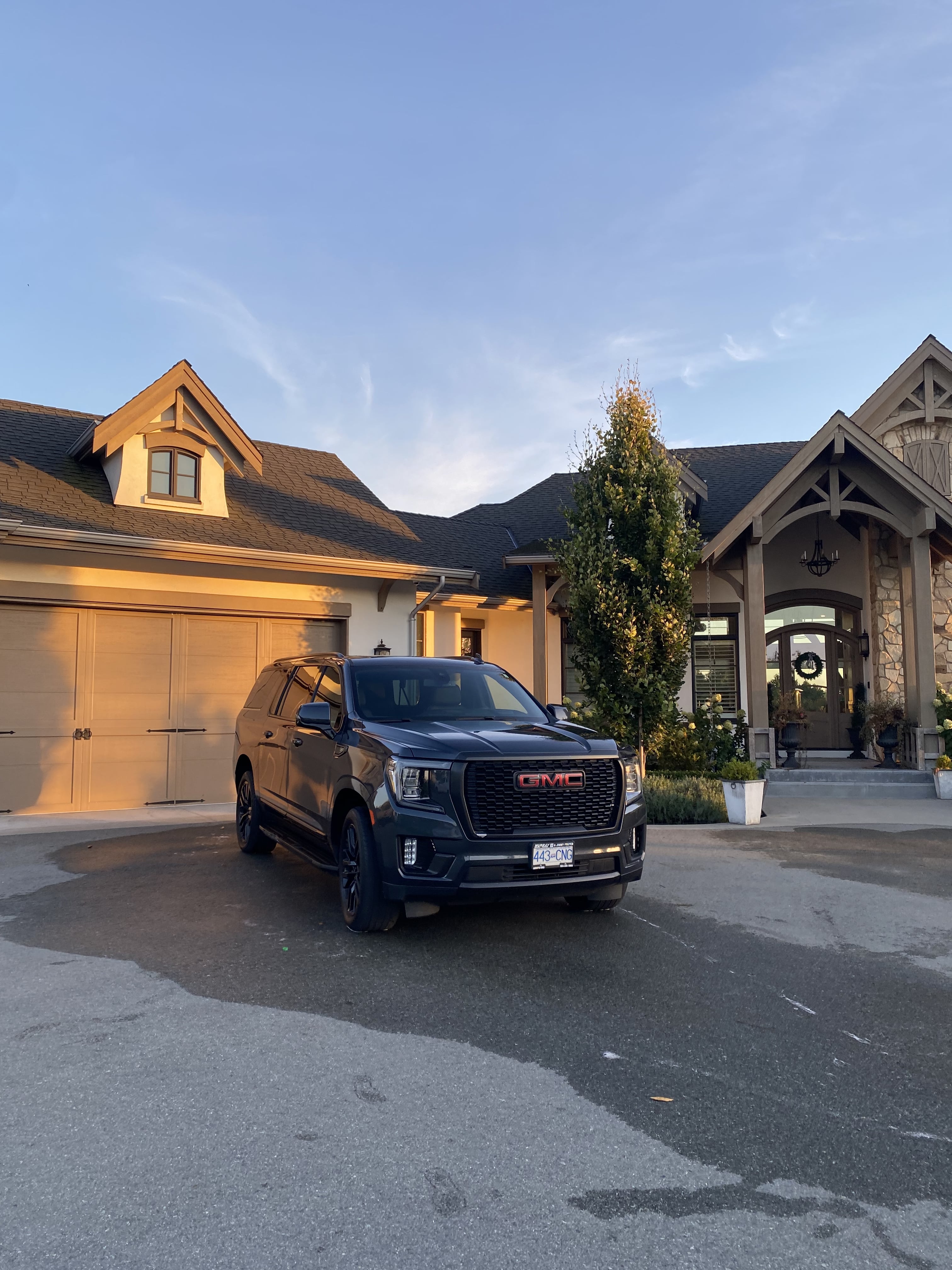 GMC SUV after full exterior detail parked in front of a home at sunset