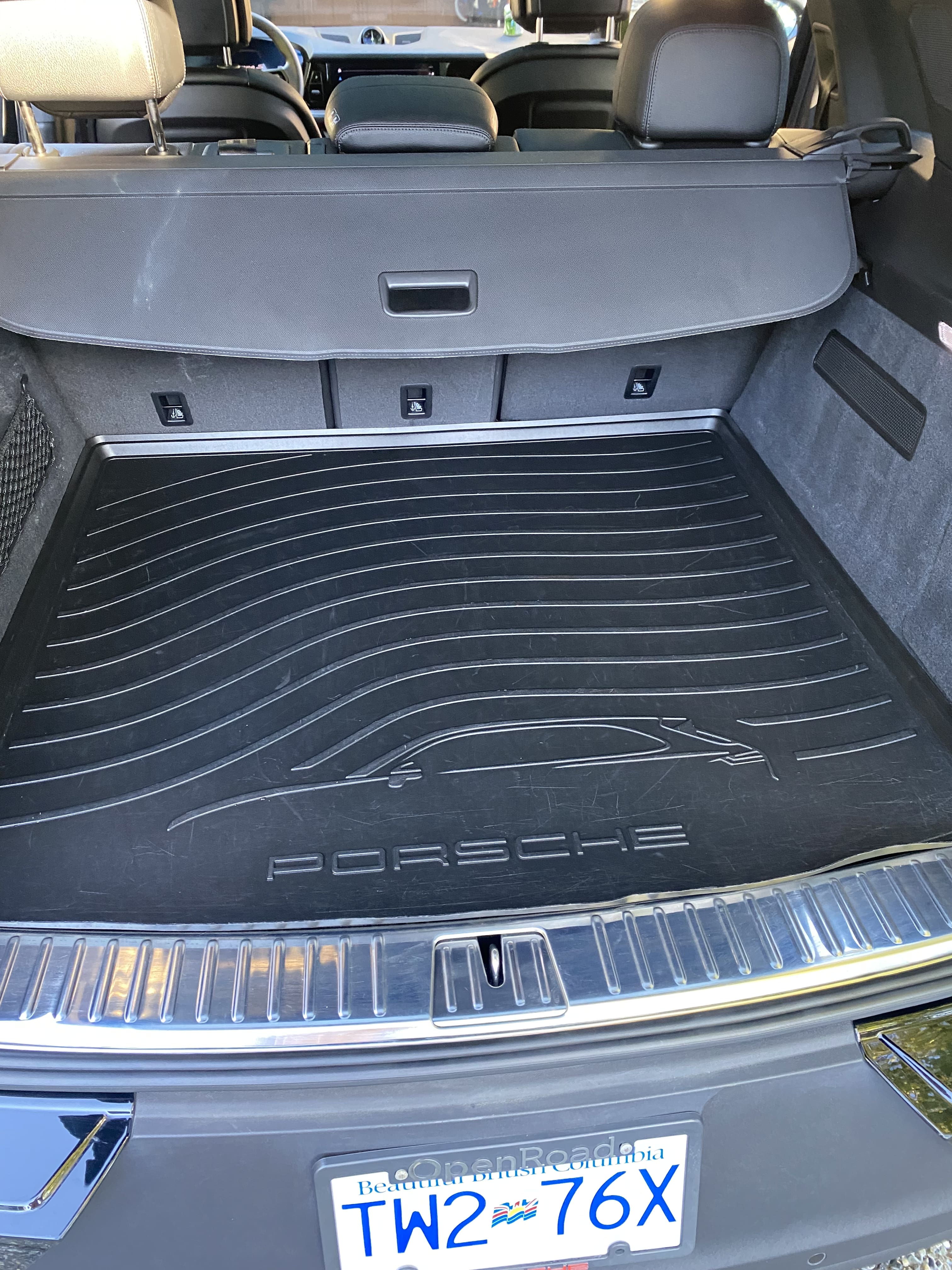 Porsche Cayenne trunk after detailing with clean mat and trim